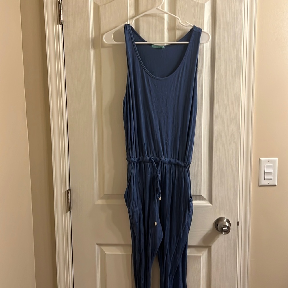 Blue jumpsuit. Large. Adjustable at waist. Tie at waist. Pockets.